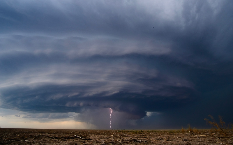 A landscape image of a storm with lightening. 