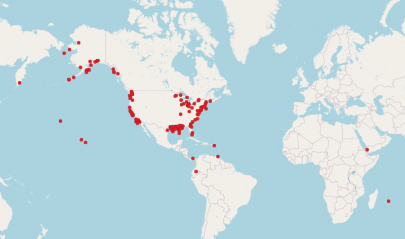 A map of the globe with red dots on it.