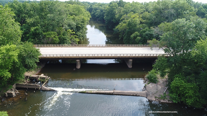 A river flows over the former dam. 