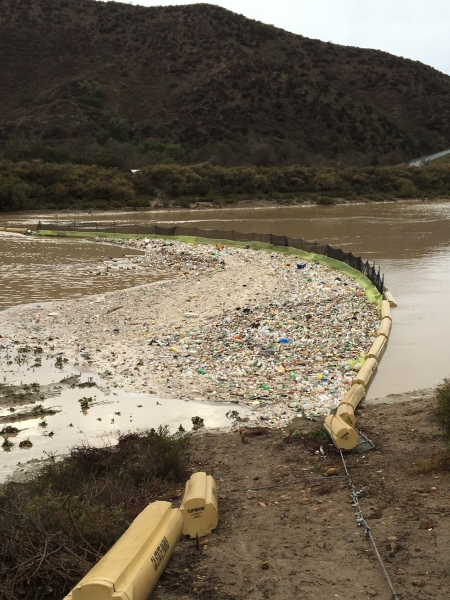 Debris accumulating in a trash boom. 