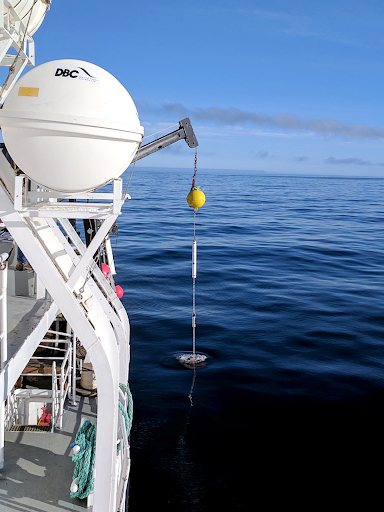 A side view of a vessel in water. 