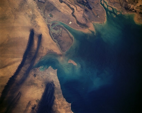 A satellite image of smoke plums across an area of land.