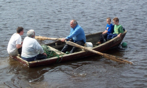 Five people in a boat. 