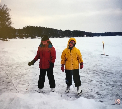 Two children ice skating.