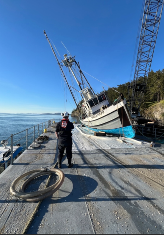 A vessel rests on a barge.