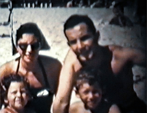 A family of four on a beach. 