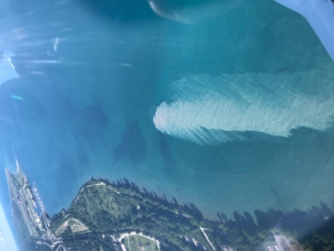 An aerial view of a plume in water. 