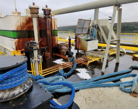 Sprayed oil observed on deck of tank barge.