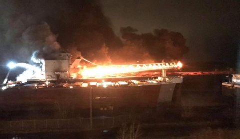 A photo taken at night of a vessel on fire.