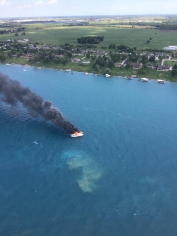 An aerial view of a ship on fire.
