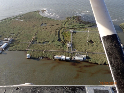 An aerial view of oil visible along a shoreline.
