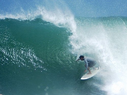 Male surfer rides a wave.