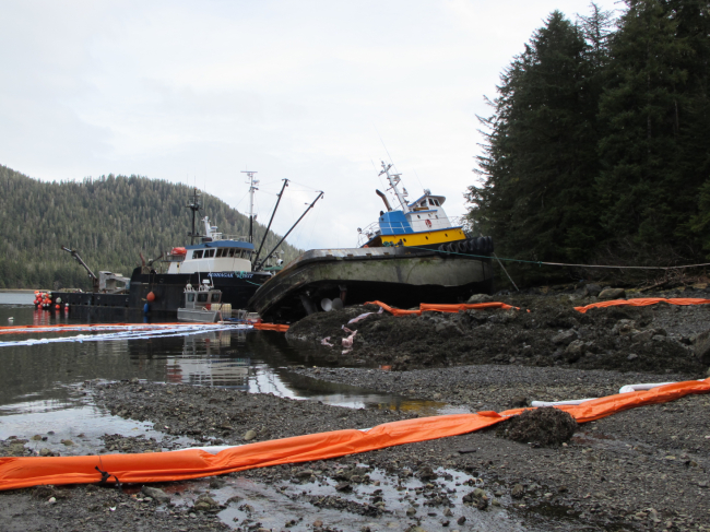 Pollution boom around a grounded vessel.