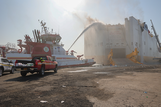 Vessels spraying water on a ship on fire.