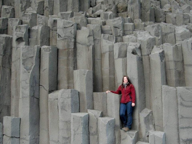 A person standing on basalt columns.