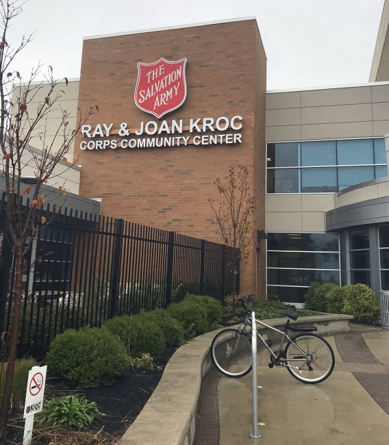 A photo of a building that reads "Salvation Army Ray & Joan Kroc Corps Community Center." 