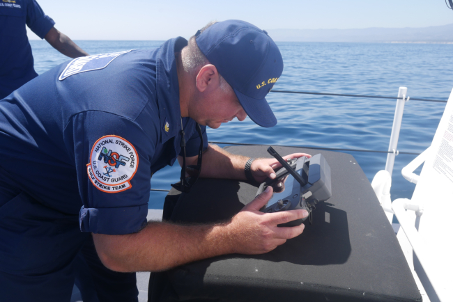 USCG drone pilot flying drones using UAS technology controls.
