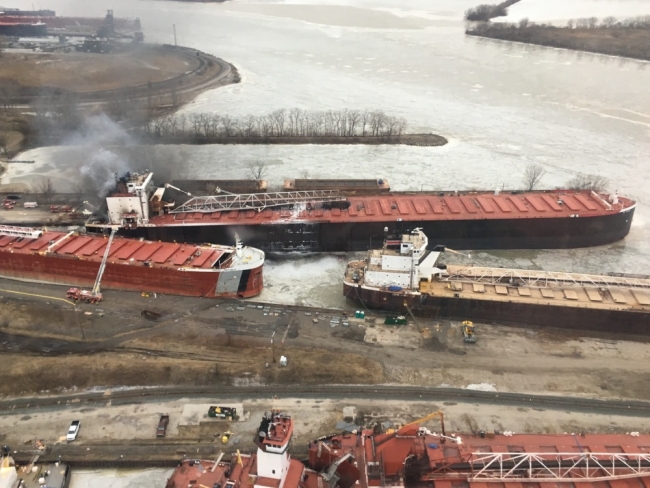 An aerial view of smoke coming from a vessel near two other vessels. 