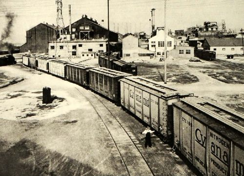 A black and white photo of an industrial railway.