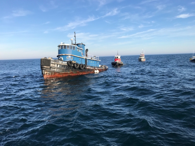A vessel pulling another vessel behind it. 