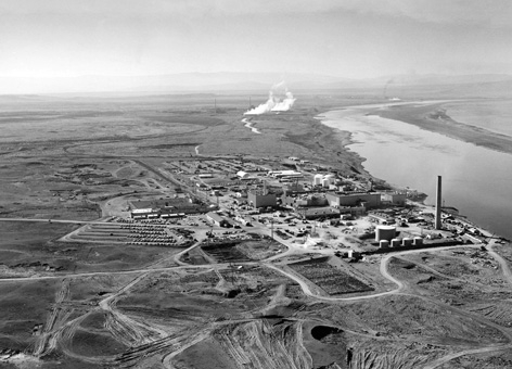 A black and white photo of nuclear reactors at an industrial site. 