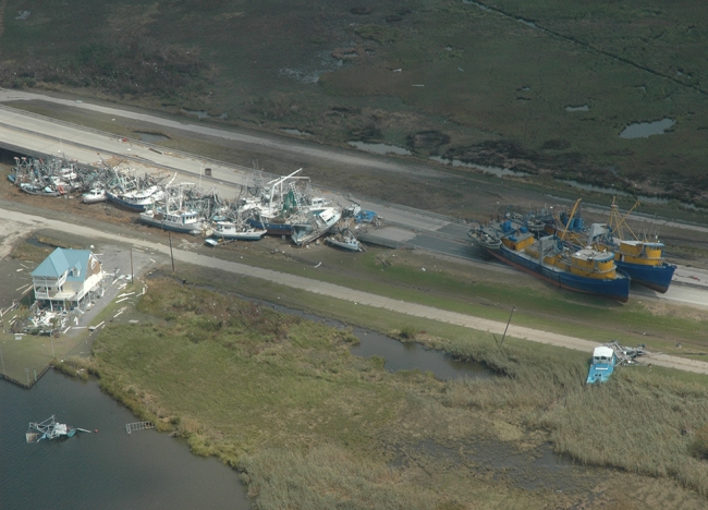 An aerial view of vessels scattered along a shoreline. 