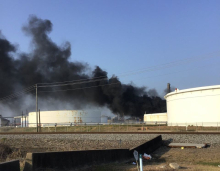 Black smoke billowing from containers.