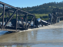 Work to remove impacted railcars from water/bridge. View from west bank of Yellowstone River, June 26, 2023. Image credit: EPA.