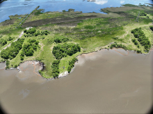 Aerial view of shoreline with boom.