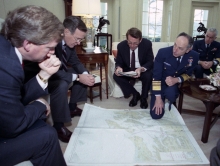 A group of people looking at a map. 